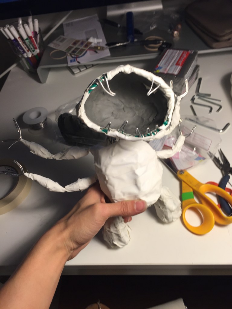 I covered the armature with gaffers tape and then spread clay over the tape